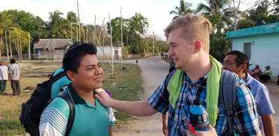 Zach talking with a man outdoors